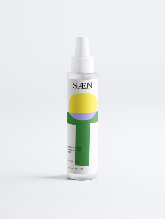 Selfnamed Keratin Shine Leave-In Hair Mist spray bottle with clear label, designed to add shine and smoothness to hair.