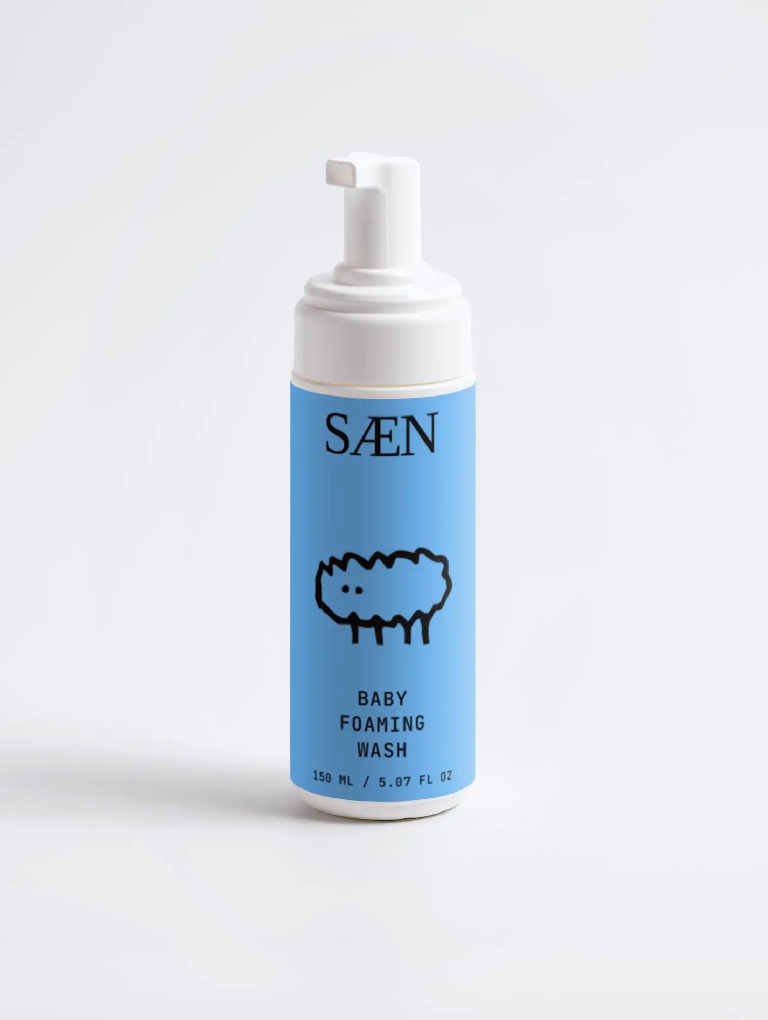 Light blue cylindrical bottle of saen baby foaming wash with a white pump dispenser and minimalist label featuring a black line drawing.
