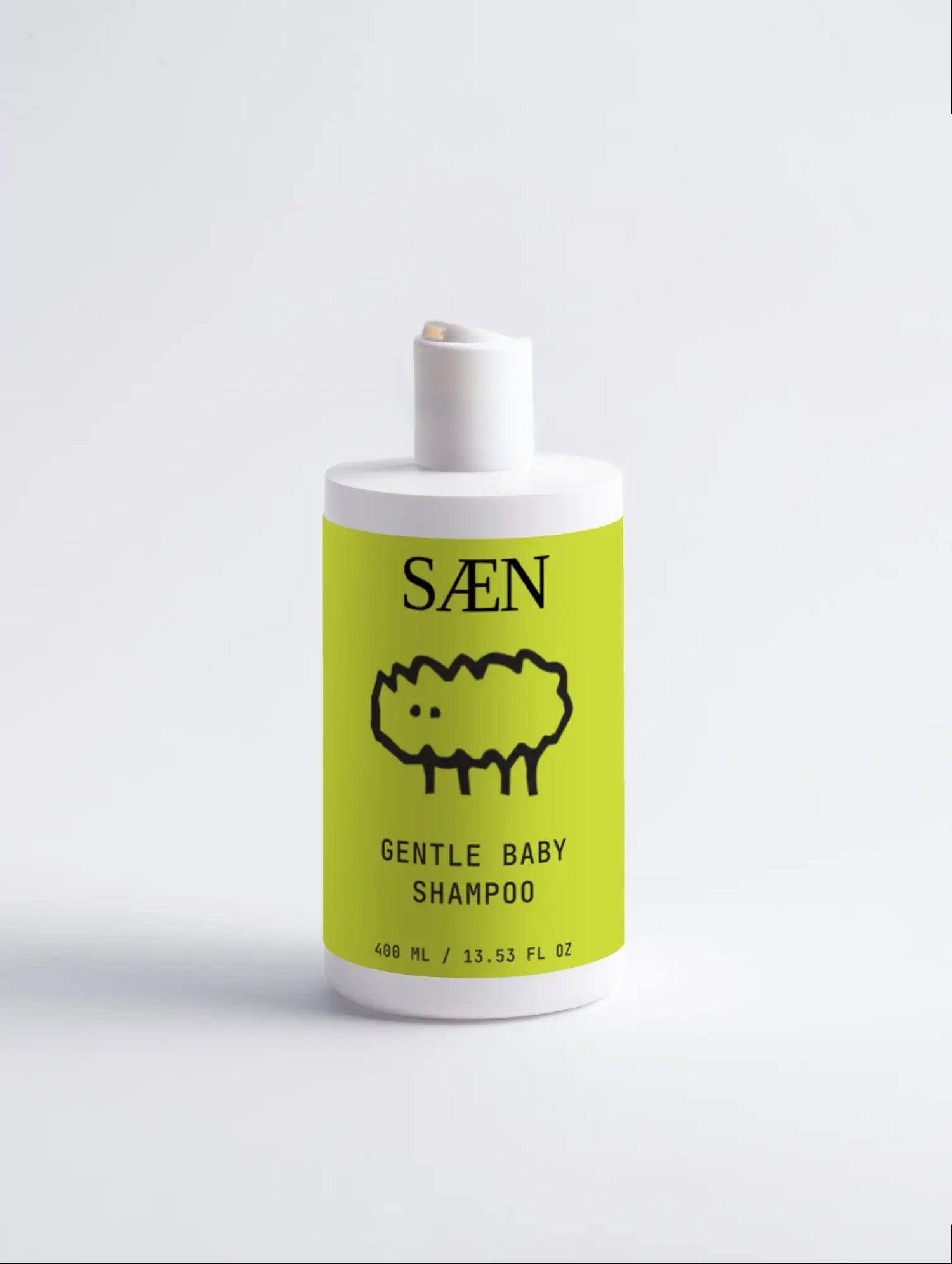 A white bottle with a bright lime green label featuring a black line drawing of a sheep and the text ’saen gentle baby shampoo’ in bold, minimalist font.
